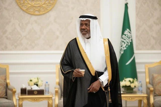 Saudi Man in Traditional Bisht Holding Coffee Cup