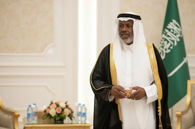 Saudi Man in Traditional Bisht Holding Arabic Coffee Cup