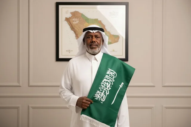 Saudi Man Holding National Flag with Map Background