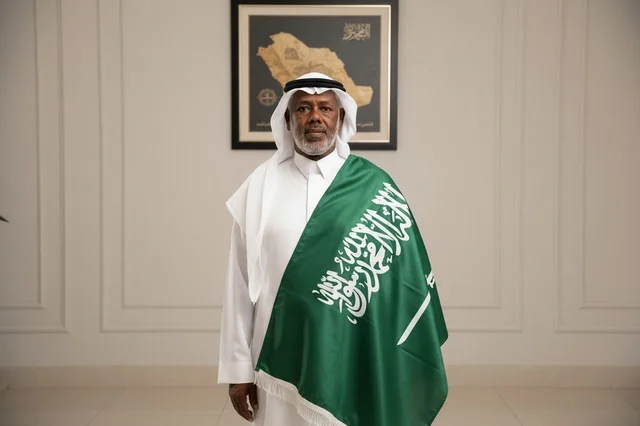 Saudi Man in Traditional Dress with National Flag