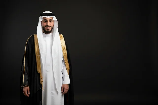 Saudi Man in Traditional Black Bisht and White Thobe