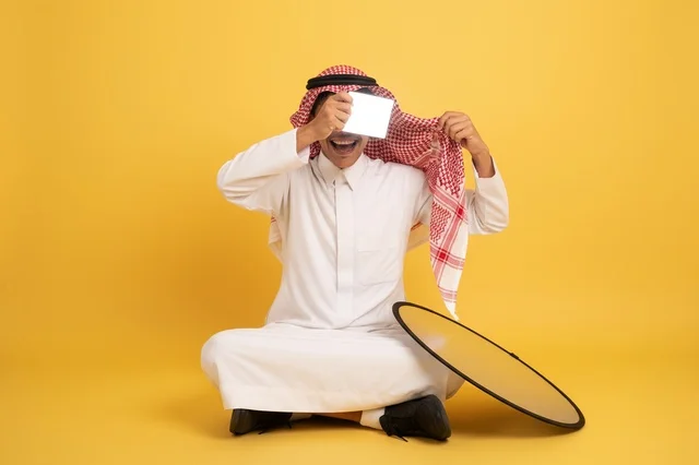 Saudi Man with Photography Reflector on Yellow Background