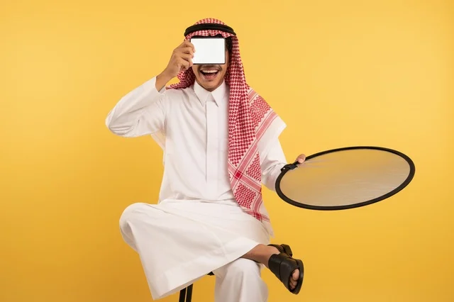 Saudi Man Holding Blank Tablet and Light Reflector