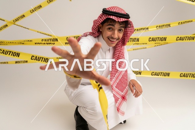 Saudi Man Behind Yellow Caution Tape in Studio