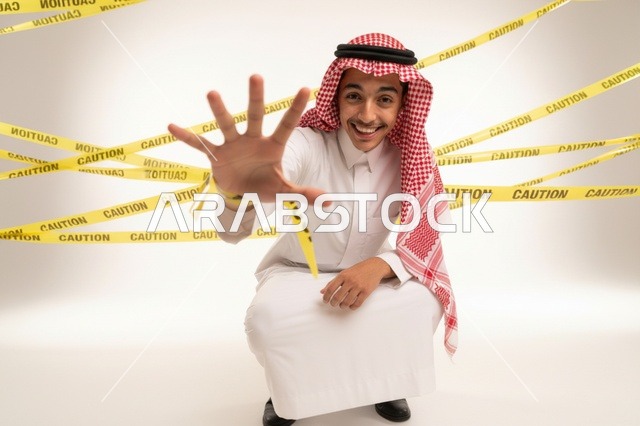 Saudi Man with Caution Tape and Stop Gesture