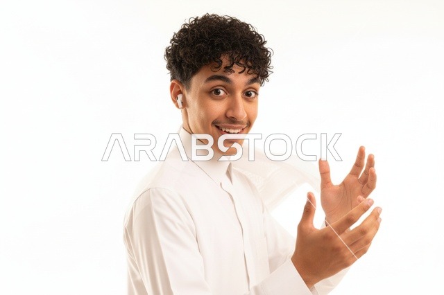 شاب سعودي بالثوب الأبيض وسماعات لاسلكية في الاستوديو