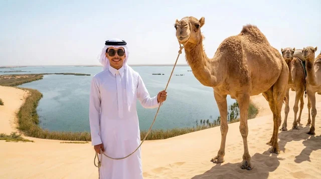 Saudi Man with Camels at Desert Lake