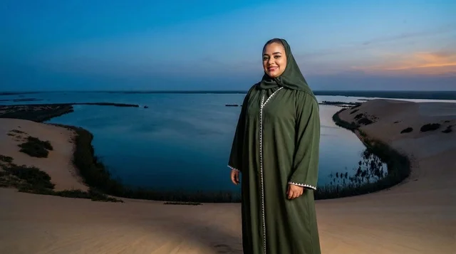 Saudi Woman in Green Jalabiya at Desert Lake Sunset