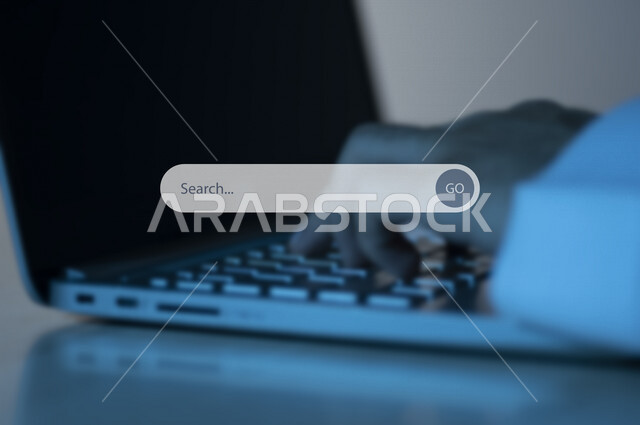 Close-up of the hand of a Saudi Arabian Gulf man using a computer, using a web search engine, a banner for entering search content, icons for search, technology and search system, Internet search mechanism