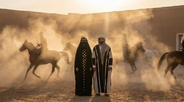 Saudi Couple in Traditional Attire with Desert Horses