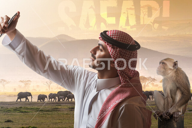 صورة لسائح عربي خليجي سعودي يقوم بالتقاط صورة تذكارية من خلال الهاتف المحمول في سفاري الرياض ، كاميرا امامية، استكشاف الحياة البرية  , فعاليات موسم الرياض , رحلة الى محميات طبيعية ,أنشطة ترفيهية سياحية , قضاء أوقات ممتعة في الإجازة الصيفية .