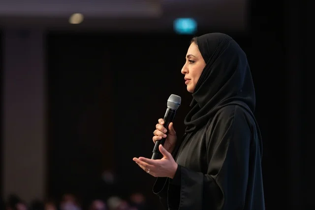 An Emirati businesswoman speaks at a professional conference.