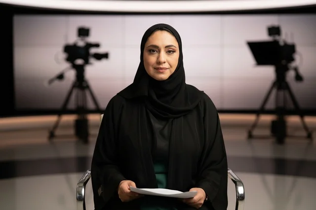Arab News Anchor in Television Studio with Cameras