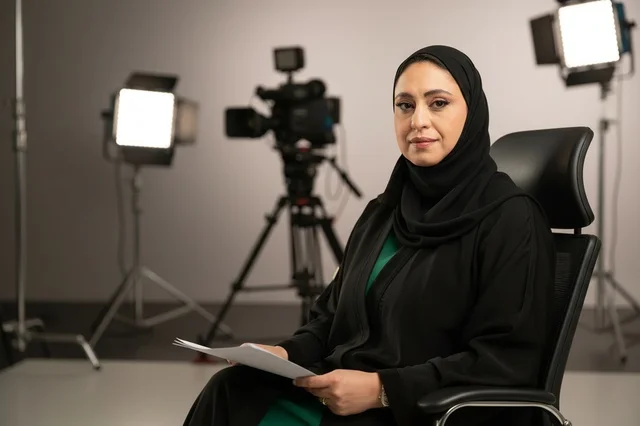 Saudi Female News Anchor in Television Studio