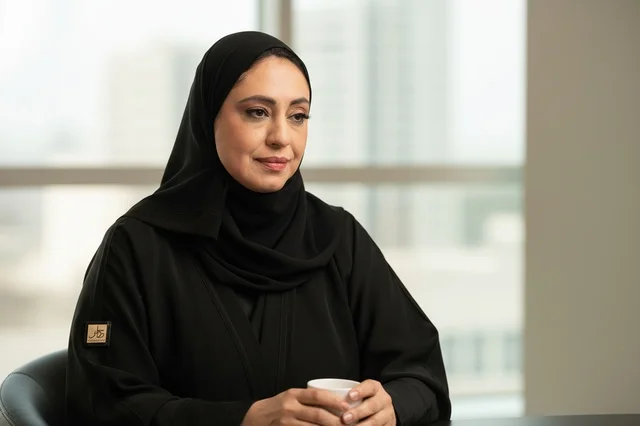 Emirati Woman in Black Abaya Holding Coffee Cup