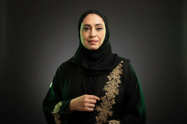 Saudi Woman in Traditional Black Abaya with Gold Embroidery Saudi Woman in Traditional Black Abaya with Gold Embroidery
