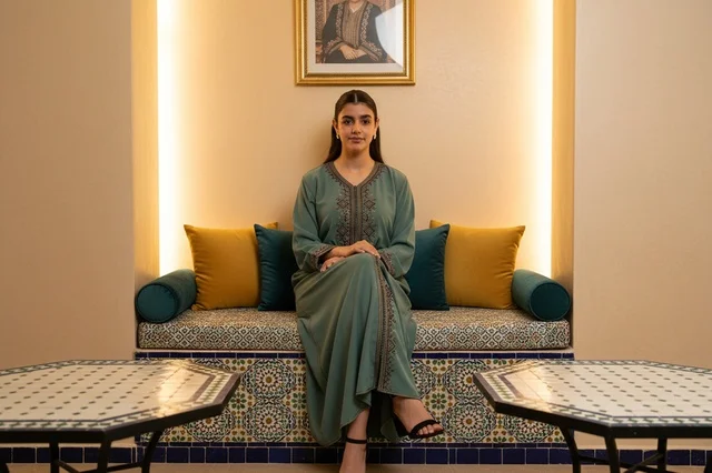 Saudi Woman in Traditional Jalabiya Sitting Indoors