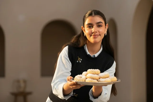 Saudi Woman Holding Traditional Maamoul Cookies