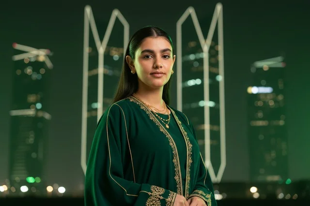 Saudi Woman in Green Abaya with Riyadh Night Skyline