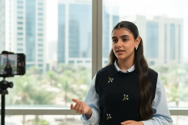 Emirati Woman Recording Business Video in Modern Office