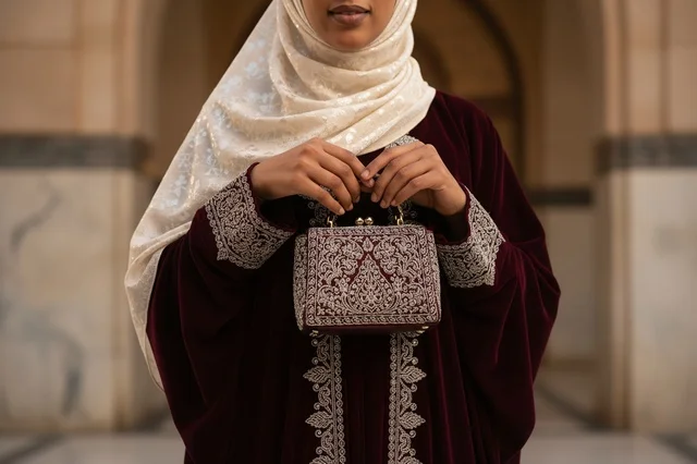 Emirati Woman in Traditional Abaya with Embroidered Bag