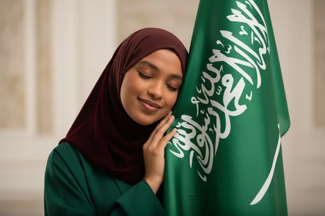 امرأة سعودية مع العلم الوطني في اليوم الوطني