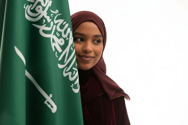 Saudi Woman with National Flag on White Background