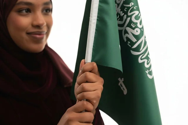 Saudi Woman Holding National Flag on White Background