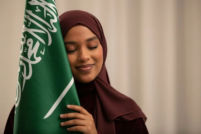 Saudi Woman with Hijab Holding Saudi Arabia Flag