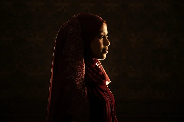 African Muslim Woman in Maroon Hijab Side Profile View