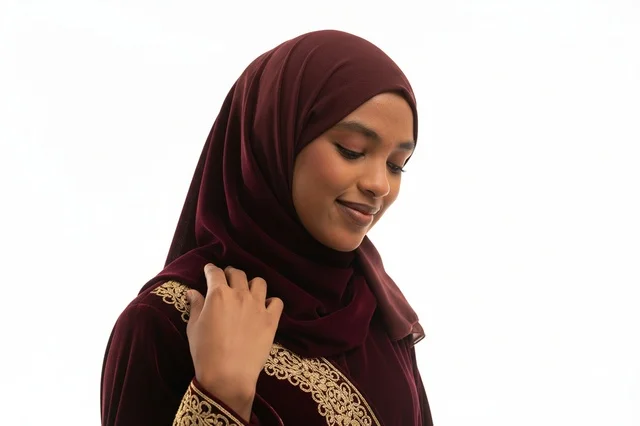 Sudanese Woman in Burgundy Velvet Jalabiya and Hijab