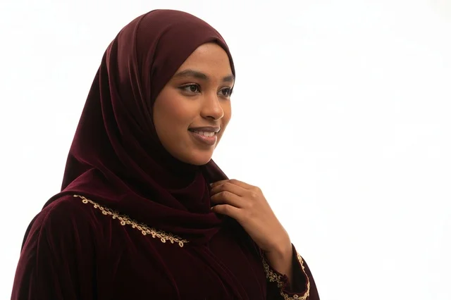 African Woman in Maroon Hijab and Velvet Jalabiya