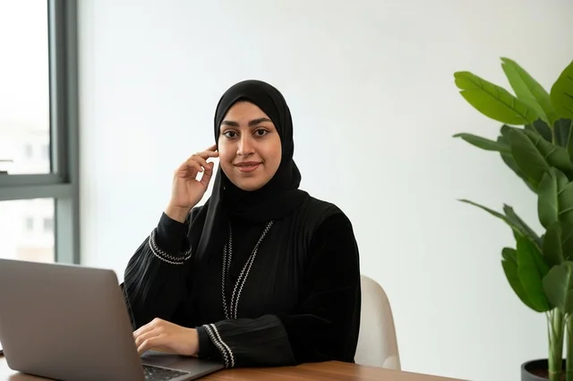 Emirati Woman Working on Laptop in Modern Office
