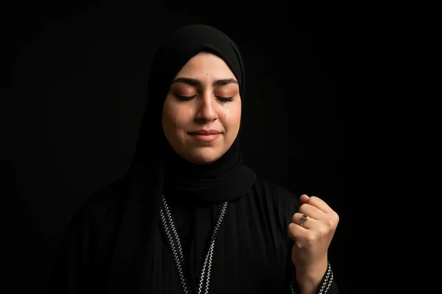 Emirati Woman in Black Abaya with Clenched Fist Portrait