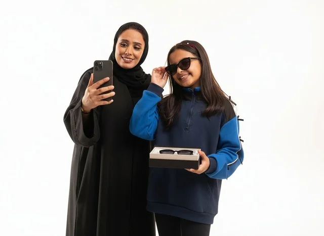 Saudi Mother and Daughter with Smartphone and Sunglasses