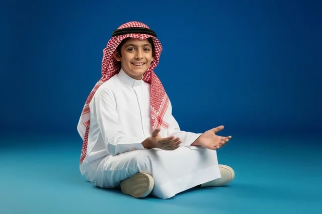 Saudi Boy in Traditional Thobe on Blue Background