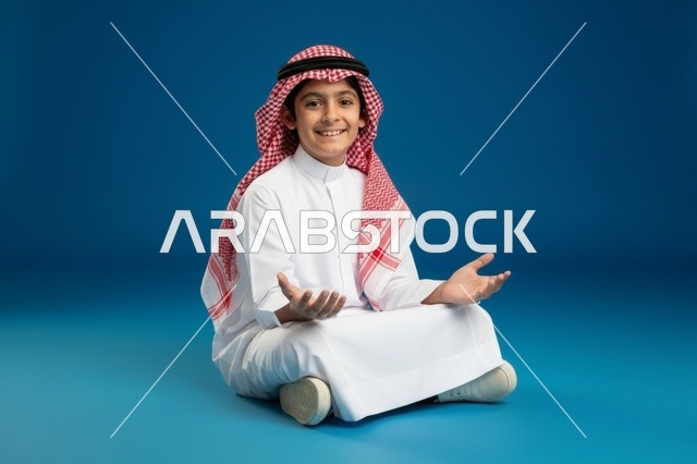 طفل سعودي بالزي التقليدي فوق خلفية زرقاء
