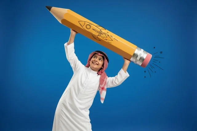 Saudi Boy Holding Giant Rocket Pencil Concept