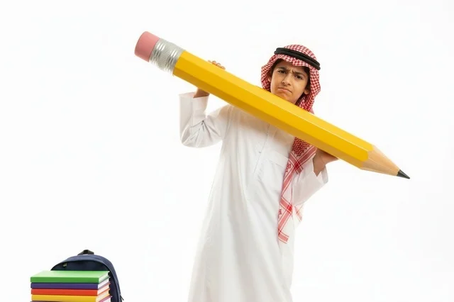 Saudi Boy in Traditional Thobe Holding Giant Pencil