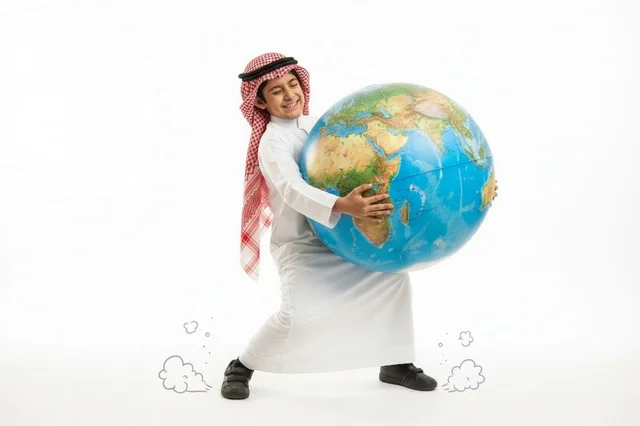 Saudi Boy in Traditional Thobe Carrying Large Globe