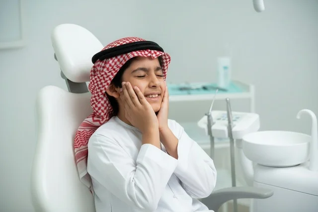 Saudi Boy with Toothache at Dentist Office