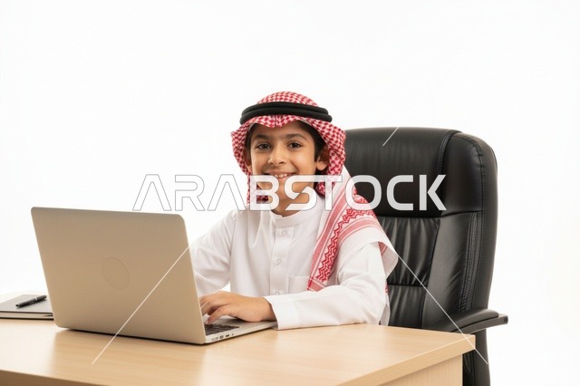 Saudi Boy Using Laptop in Traditional Clothing