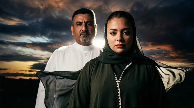 Emirati Man and Woman in Traditional Dress at Sunset