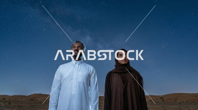 زوجان سعوديان في الصحراء تحت سماء مرصعة بالنجوم
