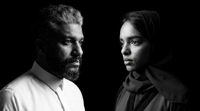 A Saudi man and woman in traditional attire in the studio.