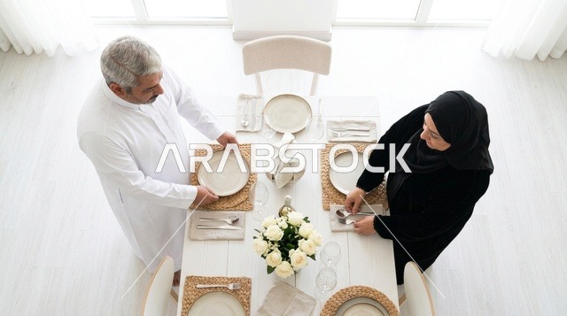 Saudi Couple Setting Dining Table in Modern Home