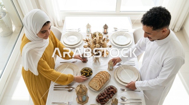 Saudi Couple Preparing Ramadan Iftar Table Indoors