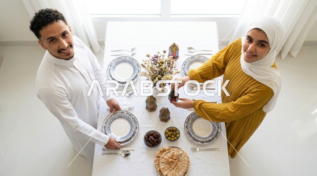 Saudi Couple Preparing Ramadan Dining Table Top View