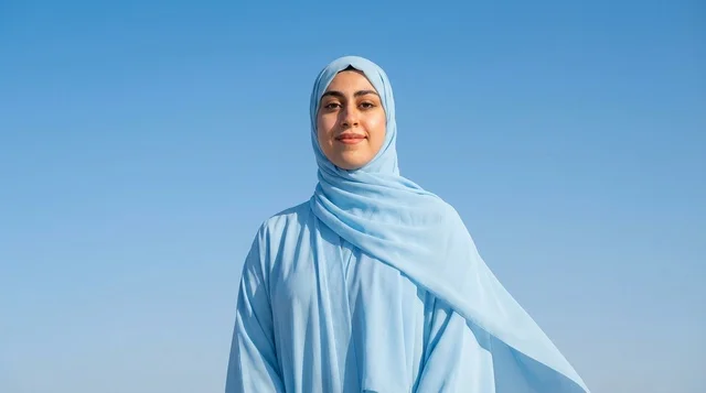 Saudi Woman in Blue Hijab Against Clear Blue Sky