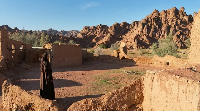 Saudi Woman in Black Abaya Among Ancient Desert Ruins